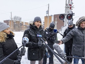 CDPQ Infra's director of public affairs, Virginie Cousineau, and Christian Ducharme, vice-president of engineering, speak to the media in front of the rail corridor on Dubuisson Ave. where the proposed REM de l'Est will run along.