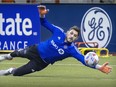 CF Montréal goalie James Pantemis makes a diving save during practice at the Olympic Stadium in Montreal on Tuesday, Jan. 25, 2022.