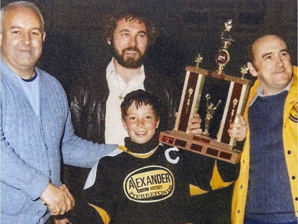 Kent Hughes (centre) accepts the trophy after his Alexander Park team from Pierrefonds won the Dollard-des-Ormeaux novice hockey tournament. Hughes, the Montreal Canadiens new general manager, grew up in the West Island. (Photos courtesy of Emerson Hughes)