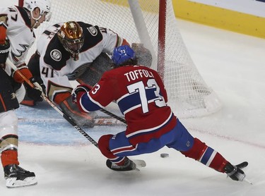 Montreal Canadiens' Tyler Toffoli (73) gets in close on Anaheim Ducks goaltender Anthony Stolarz, while Anaheim Ducks' Hampus Lindholm (47) comes in on the left during second period in Montreal on Thursday, Jan. 27, 2022.