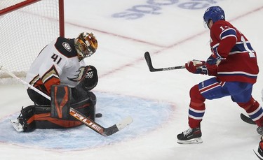 Montreal Canadiens' Nick Suzuki's (14) shot is blocked by Anaheim Ducks goaltender Anthony Stolarz during third period in Montreal on Thursday, Jan. 27, 2022.