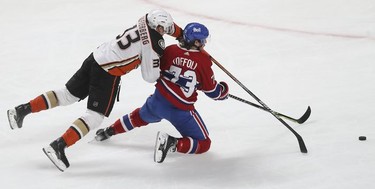Anaheim Ducks' Jakob Silfverberg (33) dives on Montreal Canadiens' Tyler Toffoli (73) and brings him down as they race for the puck during third period in Montreal on Thursday, Jan. 27, 2022.