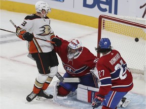 Ducks' Jakob Silfverberg watches puck go past Canadiens goaltender Cayden Primeau and Alexander Romanov during the first period Thursday night at the Bell Centre.