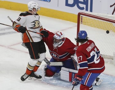 Anaheim Ducks' Jakob Silfverberg (33) watches puck go past Montreal Canadiens goaltender Cayden Primeau and Alexander Romanov (27) during first-period action in Montreal on Thursday, Jan. 27, 2022.