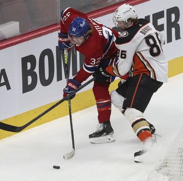 Montreal Canadiens' Rem Pitlick (32) and Anaheim Ducks' Simon Benoit (86) battle for puck during first-period action in Montreal on Thursday, Jan. 27, 2022.