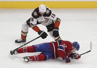 Anaheim Ducks' Ryan Getzlaf (15) brings down Montreal Canadiens' Rem Pitlick (32) during first-period action in Montreal on Thursday, Jan. 27, 2022.