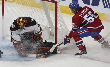 Montreal Canadiens' Michael Pezzetta (55) tries to get puck past Anaheim Ducks goaltender Anthony Stolarz during second period in Montreal on Thursday, Jan. 27, 2022.