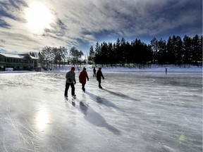 Skaters cast long shadows on a sunny day on the frozen lake at the Laval Nature Centre in 2020.
