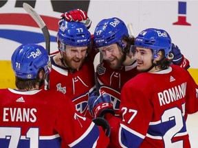 Montreal Canadiens Josh Anderson, second from right, with teammates Jake Evans, Brett Kulak and Alexander Romanov in July. Evans and Romanov entered the NHL's COVID protocol Jan. 1, 2022.