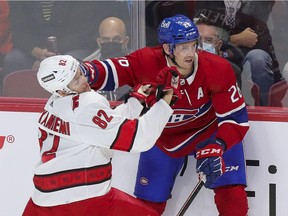 Montreal Canadiens defenceman Jeff Petry keeps Carolina Hurricanes' Jesperi Kotkaniemi at bay during first period in Montreal on Oct. 21, 2021.