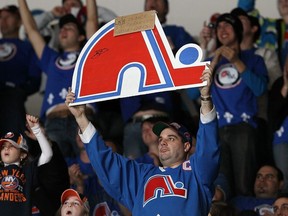 Members of 'Nordiques Nation' cheer during the NHL game between the New York Islanders and the Atlanta Thrashers on Dec. 11, 2010 at Nassau Coliseum in Uniondale, N.Y. Over 1,100 fans from Quebec attended the game to prove their support for an NHL team.