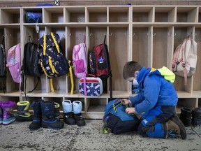 A student gets his books ready at Willingdon Elementary school on the first day back to class after an extended holiday break.