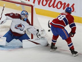 Montreal Canadiens' Christian Dvorak (28) tries for the return on Colorado Avalanche goaltender Jonas Johansson during second period NHL action in Montreal on Thursday December 02, 2021.