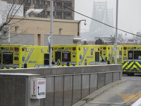 Ambulances wait outside the emergency room at Notre-Dame Hospital on Wednesday, Dec. 22, 2021.