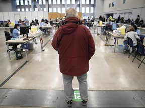 A man waits in line at the COVID vaccination clinic at the Palais des congrès on Thursday December 30, 2021. "Vaccination, especially after having received a booster, provides very good protection against severe infection and hospitalization," Dr. Christopher Labos writes.