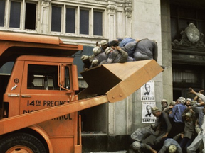 A still from the 1973 film Soylent Green, which depicts a dystopian 2022 in which the world is severely overpopulated and riots are cleared away with modified garbage trucks.
