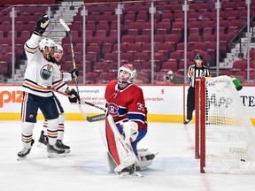 Edmonton Oilers' Evander Kane (91) celebrates his first goal of the season while Canadiens goaltender Sam Montembeault reacts during the first period at the Bell Centre on Saturday, Jan. 29, 2022, in Montreal.