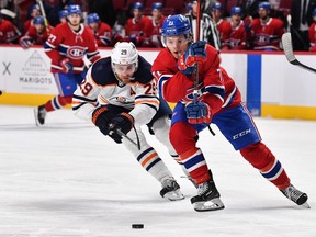 Leon Draisaitl (29) of the Edmonton Oilers and Canadiens' Jake Evans skate after the puck during the second period at the Centre Bell on Saturday, Jan. 29, 2022, in Montreal.
