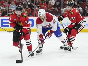 Joel Armia of the Montreal Canadiens pursues Brandon Hagel of the Chicago Blackhawks during the first period at United Center on Jan. 13, 2022, in Chicago.