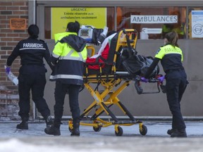 Paramedics wheel a patient to the emergency department at Saint-Mary's Hospital in Montreal.