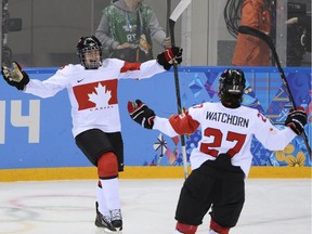 Mélodie Daoust celebrates with teammate Tara Watchorn during the women's ice hockey semifinals against Switzerland at the Sochi Olympics in 2014.