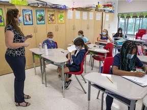 A Grade 3 teacher and students wear masks in class at a Lester B. Pearson School Board elementary school in the West Island on Sept. 9, 2021.