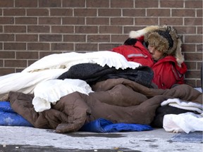 A man tries to find ways to stay warm as the city deals with a cold snap, in Montreal, on Sunday, Jan. 16, 2022.