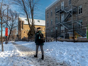 A Montrealer walks past the scene of a shooting on Roy St. near Rivard St. on Jan. 14, 2022. Amir Benayad, 17, died of his injuries after he was shot there the day before.