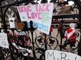 Protest signs are seen attached to the main gate to Parliament Hill, as demonstrations by truckers and their supporters against the coronavirus disease (COVID-19) vaccine mandates continue in Ottawa Jan. 31, 2022.