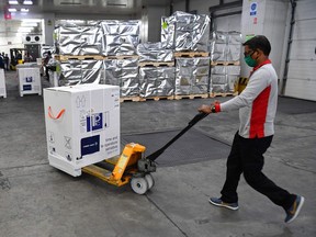 Doing nothing to prevent the emergence of new variants will serve us poorly in the long term, Christopher Labos writes. Above: Boxes of vaccine developed by the Serum Institute of India are stacked at Mumbai airport as part of the COVAX program.