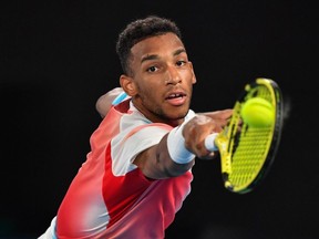 Montreal's Félix Auger-Aliassime hits a shot against Russia's Daniil Medvedev during their men's singles quarter-final match at the Australian Open in Melbourne on Jan. 26, 2022.
