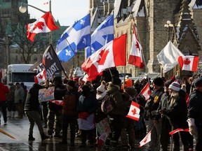 Supporters of the Freedom Convoy protest against COVID-19 vaccine mandates and restrictions in front of the Parliament of Canada on Friday, Jan. 28, 2022, in Ottawa.