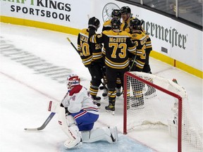Canadiens goaltender Jake Allen reacts as Bruins players congratulate Brad Marchand after one of the winger's two first-period goals Wednesday night in Boston.