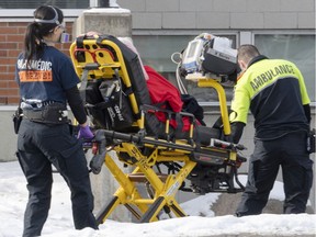 Ambulance workers transport a patient to the emergency room as hospitalizations continue to rise due to the COVID-19 pandemic Wednesday, January 5, 2022  in Montreal.