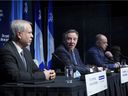 Dr. Luc Boileau, left, Quebec's new interim director of public health, is presented by Premier François Legault with Health Minister Christian Dube during a news conference in Montreal, Tuesday, January 11, 2022.