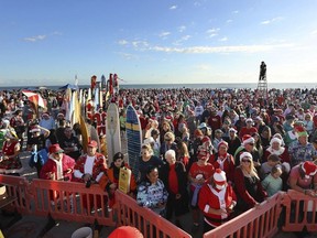 Thousands packed the beach during the "Surfing Santas" event at Cocoa Beach, Fla., last month. Trying to describe to Quebecers how wildly differently Floridians are living while we’ve been penned in drew a lot of ire, Josh Freed writes.