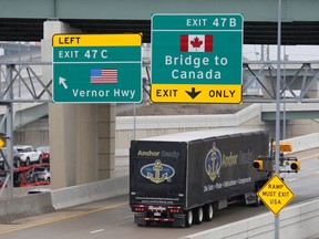 A commercial truck heads for the Ambassador Bridge , during the coronavirus disease (COVID-19) outbreak, at the international border crossing, which connects with Windsor,  in Detroit on March 18, 2020.