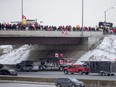 Supporters of truckers gather on a highway overpass in Toronto to support truck drivers on their way to Ottawa to protest vaccine mandates for cross-border truck drivers.