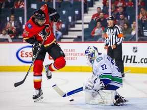 Vancouver Canucks goaltender Richard Bachman makes a save on Calgary Flames' Devante Smith-Pelly during exhibition game on Sept. 16, 2019, in Calgary.