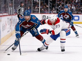 Colorado Avalanche's J.T. Compher (37) and Canadiens' Brett Kulak (77) battle for the puck in the second period at Ball Arena on Saturday, Jan. 22, 2022, in Denver.