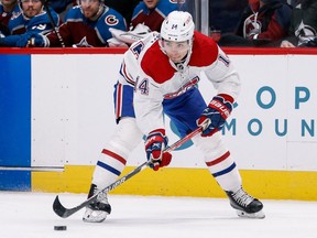 Canadiens' Nick Suzuki controls the puck in the first period against the Colorado Avalanche at Ball Arena on Saturday, Jan. 22, 2022, in Denver.