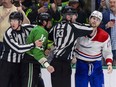 NHL linesman Matt MacPherson (83) and linesman Trent Knorr (74) separate Montreal Canadiens right wing Josh Anderson (17) and Dallas Stars left wing Jamie Benn (14).