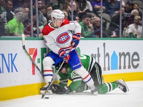 Montreal Canadiens centre Nick Suzuki (14) skates over Dallas Stars defenceman Ryan Suter (20) Jan. 19, 2022.