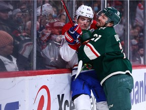 Wild's Brandon Duhaime slams Canadiens defenceman Chris Wideman during second-period action at the Xcel Energy Center Monday night.