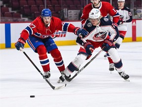 Columbus Blue Jackets' Patrik Laine (29) plays the puck against Canadiens defenceman Alexander Romanov (27) during the first period at the Bell Centre on Sunday, Jan. 30, 2022, in Montreal.