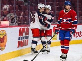 Columbus Blue Jackets centre Jack Roslovic (96) celebrates his goal with centre Max Domi (16) during the first period at Bell Centre in Montreal on Sunday, Jan. 30, 2022.