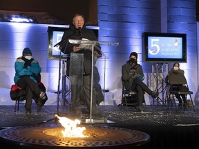 Quebec Premier François Legault speaks as Boufeldja Benabdallah of the Quebec Islamic Centre, left, looks on during a vigil marking the fifth anniversary of the Jan. 29, 2017, mosque shooting that killed six people, in Quebec City, Saturday, Jan. 29, 2022.