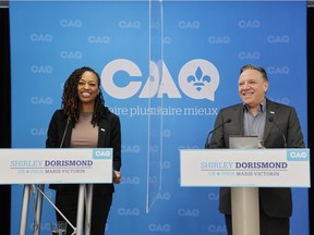 Shirley Dorismond, left, the Coalition Avenir Québec candidate for the byelection in Marie-Victorin riding, is introduced by Premier François Legault on Sunday, Jan. 30, 2022.