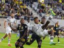 FC Montreal's Romell Quioto attempts an overhead kick while Columbus Crew's Harrison Afful defends in the first half in Columbus, Ohio on September 25, 2021.