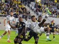 CF Montréal's Romell Quioto attempts an overhead kick while Columbus Crew's Harrison Afful defends during first half in Columbus, Ohio, on Sept. 25, 2021.